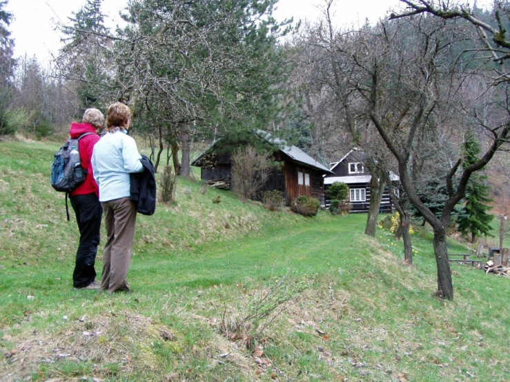 a man and woman that are standing on a hill