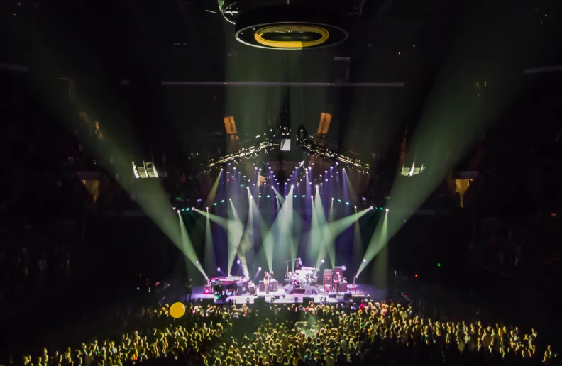 a large auditorium filled with many lights and colored stage lighting