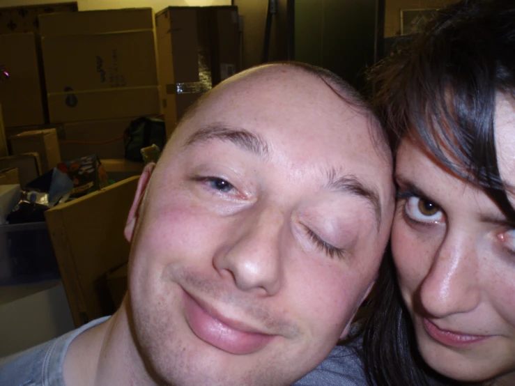 two people in a large room with boxes on the wall