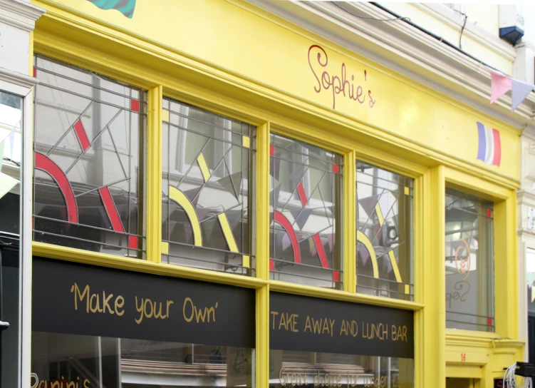 two shops with signs on the side of them advertising