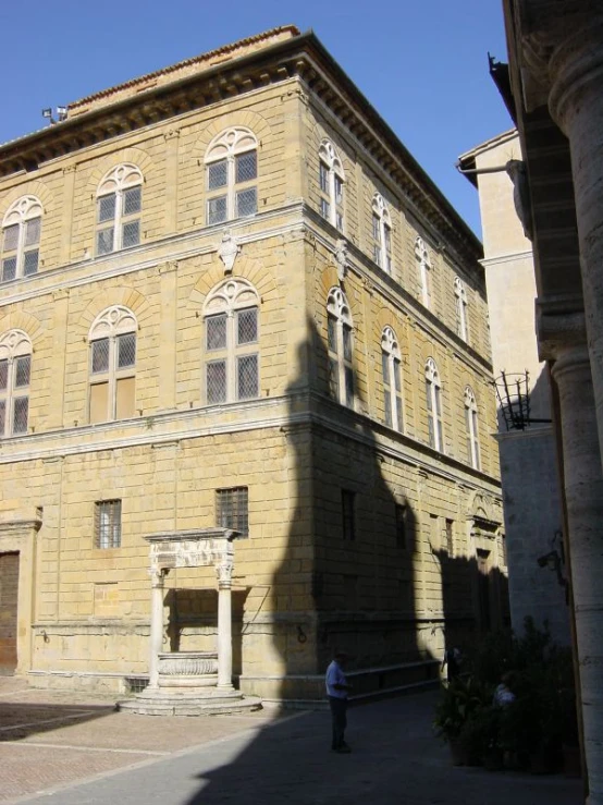 the shadow of a man standing outside of an old building