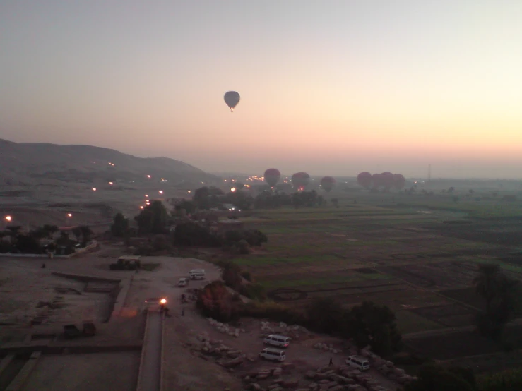 a  air balloon flying over a large field