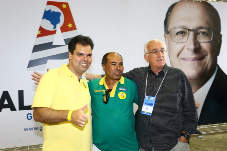 three men pose for the camera at an event