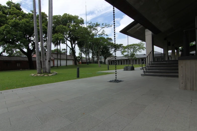 walkways in the center of park next to grass and palm trees