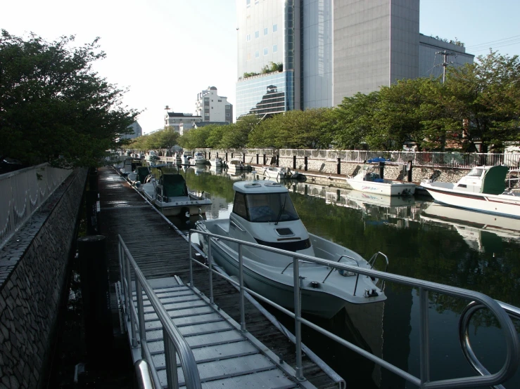 a boat traveling down the water by a long dock