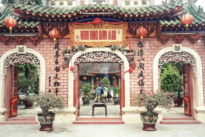 an asian style building with large windows and red stone arches