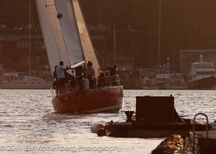 people on a sailboat ride through a marina