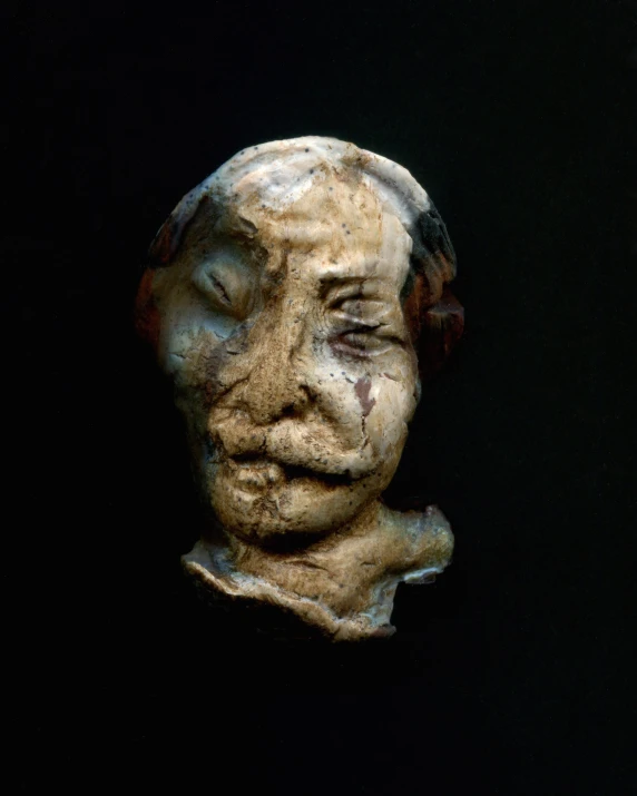 a sculpture of a woman's face covered in paint