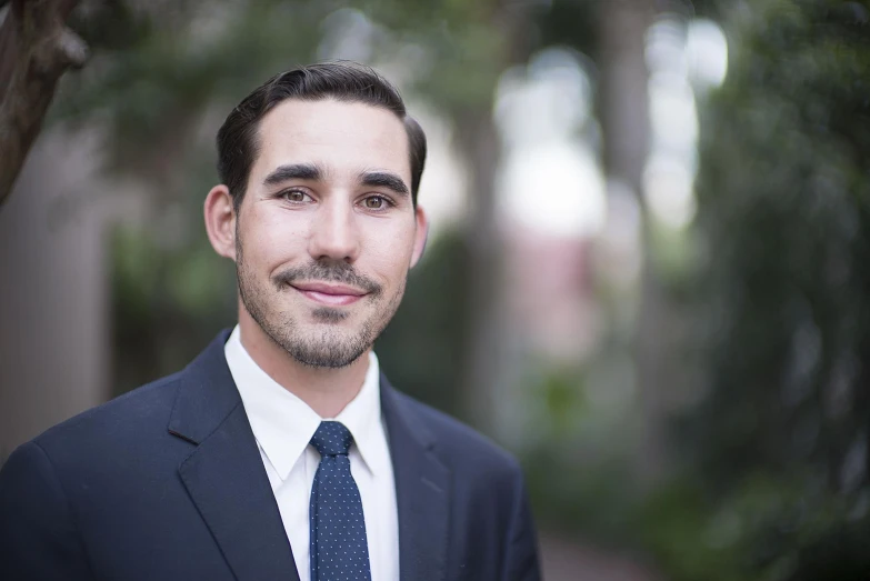 a close up of a person in a suit and tie