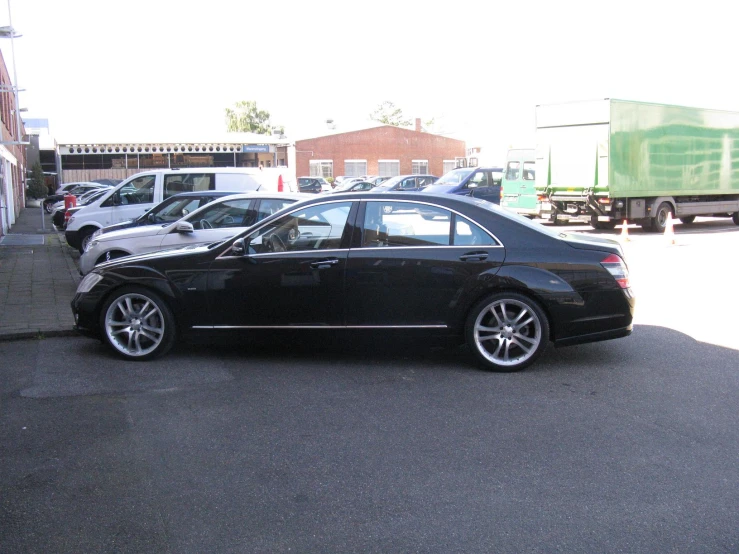 black mercedes benz parked in an empty parking lot