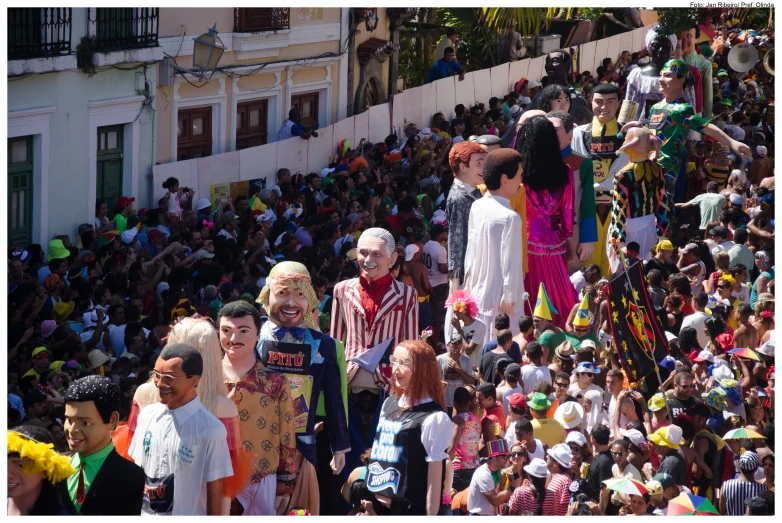 people standing on a slope watching clowns on a float