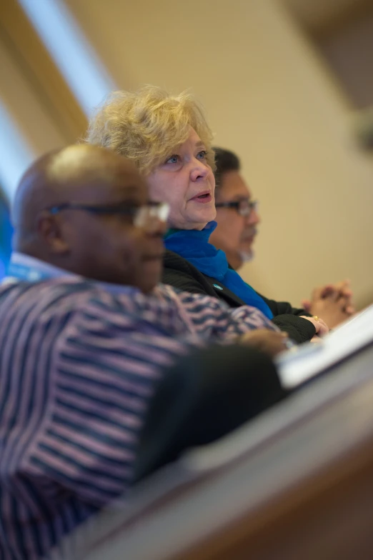 a couple of people sitting next to each other at a desk