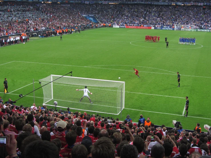 soccer players playing a game on the field in a stadium