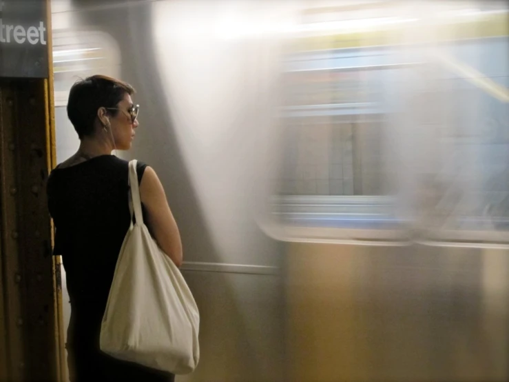 a woman waiting for a train in the subway