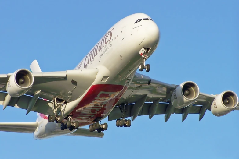 a passenger jet is in the air above the ground