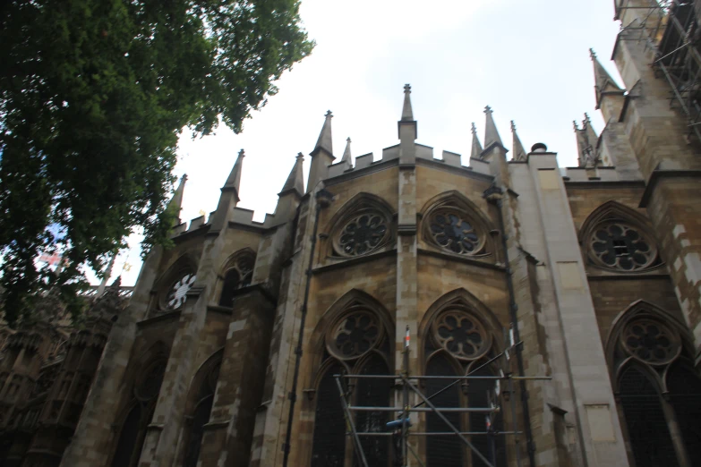 a very large cathedral with clock tower that is going up