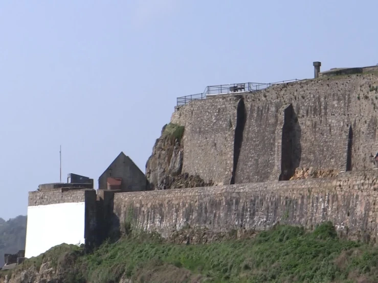 a hill that is surrounded by a giant cliff