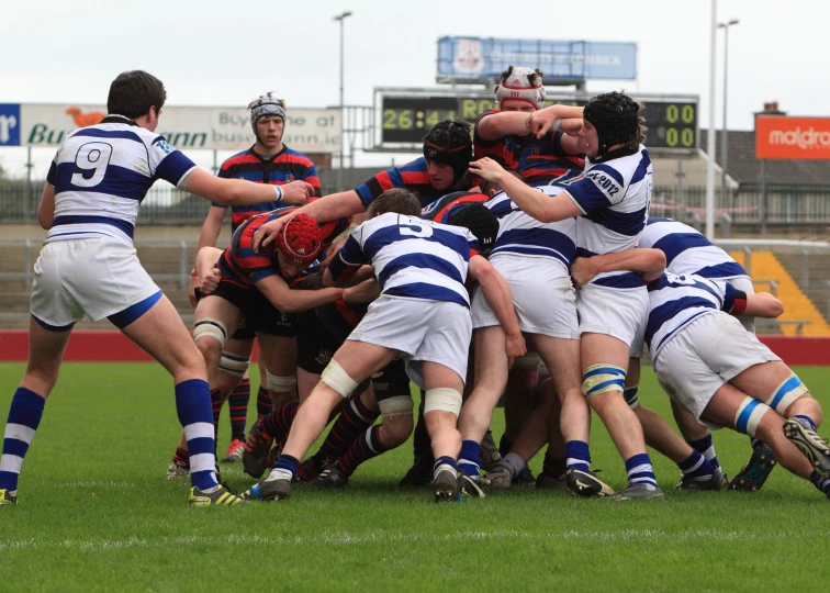 a team of men fighting for the ball on a field