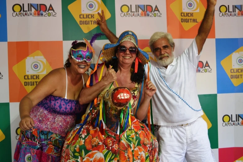 three women and a man standing together at an outdoor event