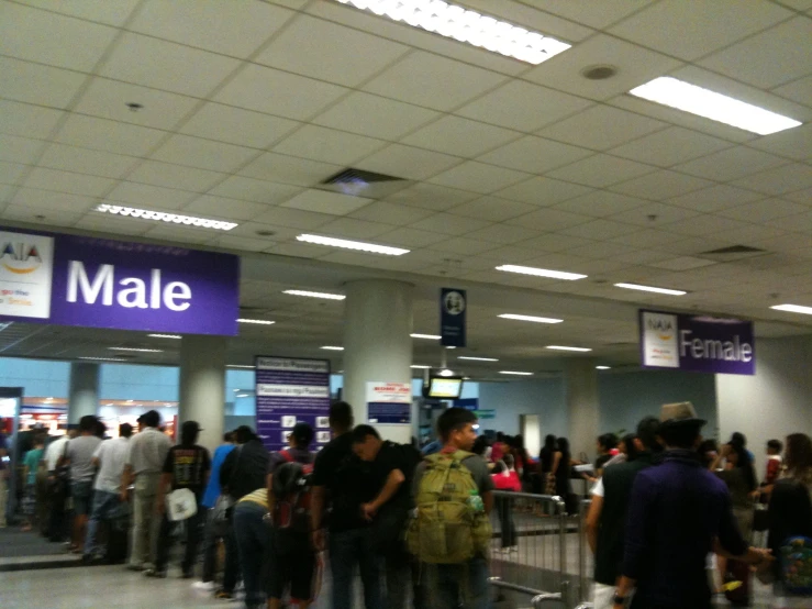 many people waiting in line at an airport