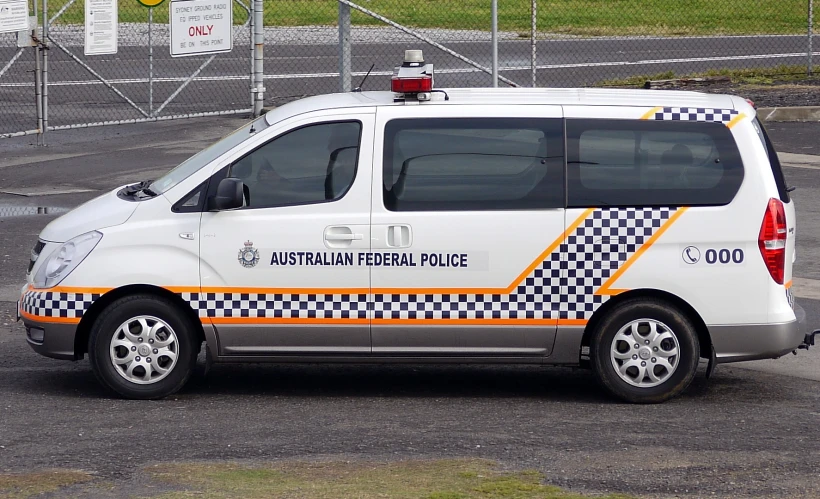 a car with checkered stripes driving down the street