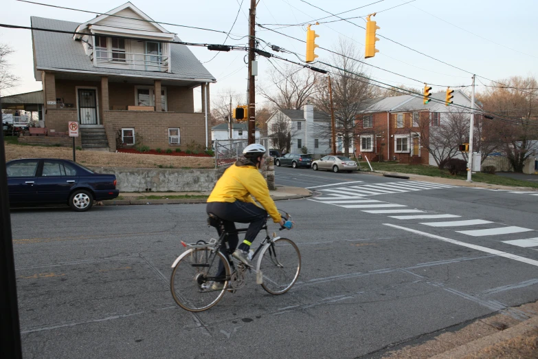 a man riding his bike down a street