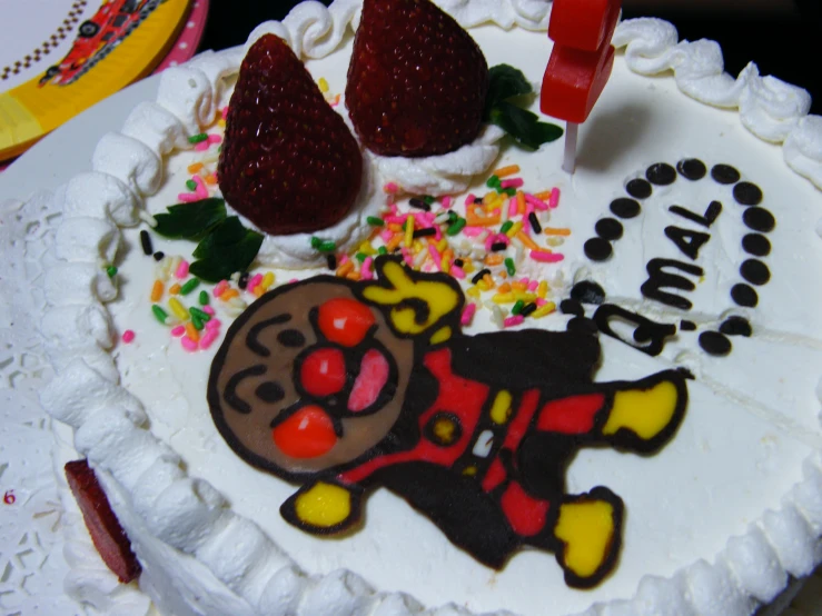 a white cake decorated with raspberries and icing on a table