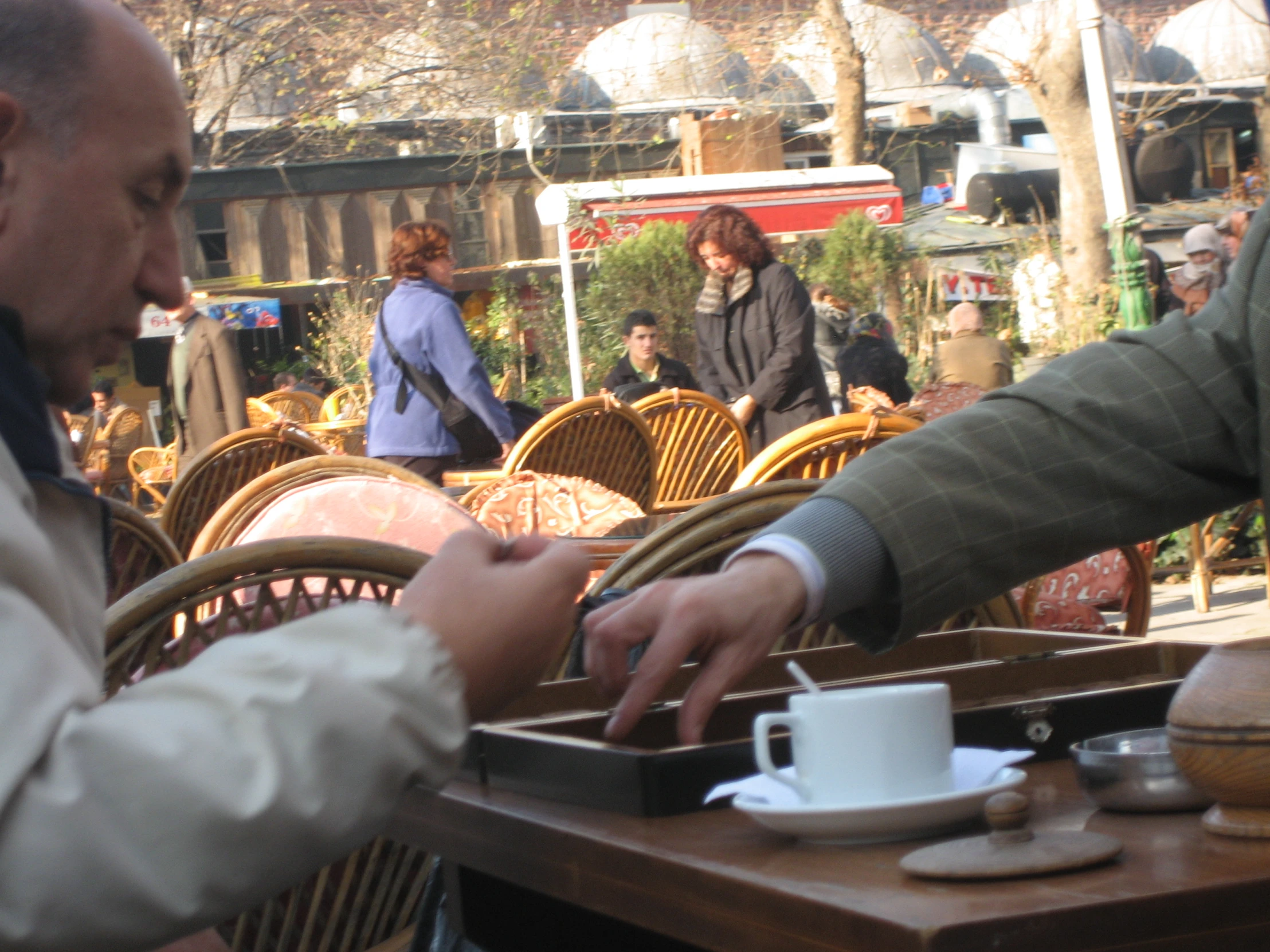 man with grey hair and glasses serving himself from white cup