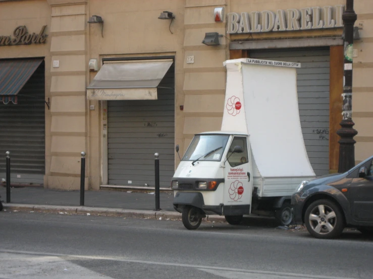 a white truck is parked in front of a building