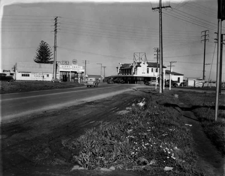 an old po shows a road with houses and a telephone pole