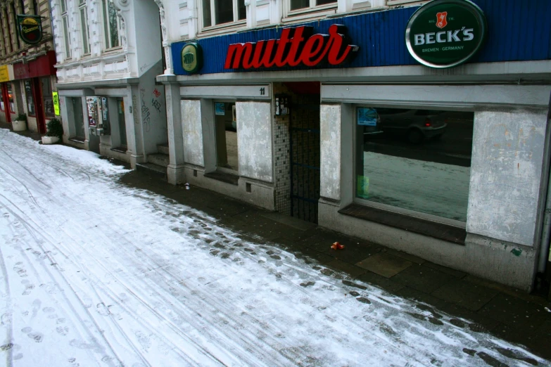 snow covers the ground at a store called mutter's