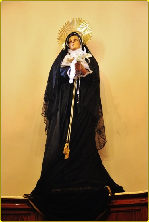 an statue of the immaculate mary in black