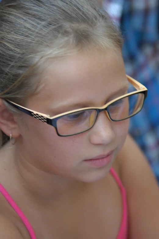 the girl wears glasses with gold detailing on both sides