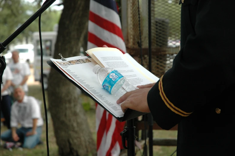 a person in uniform is reading a book on a stage