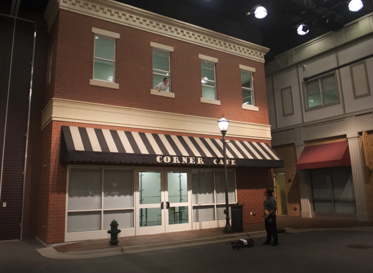 a man standing in front of a coffee shop