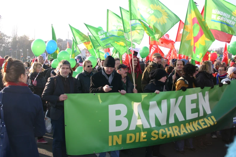 many people with green flags and banners