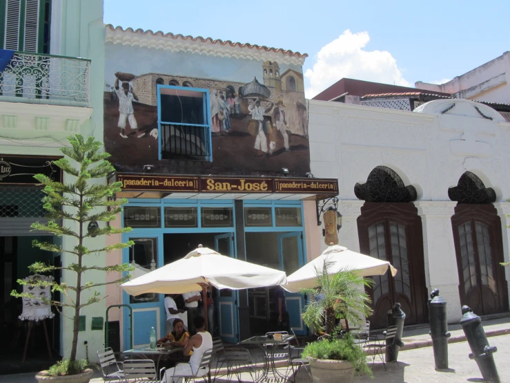 outdoor cafe and restaurant patio with white umbrellas