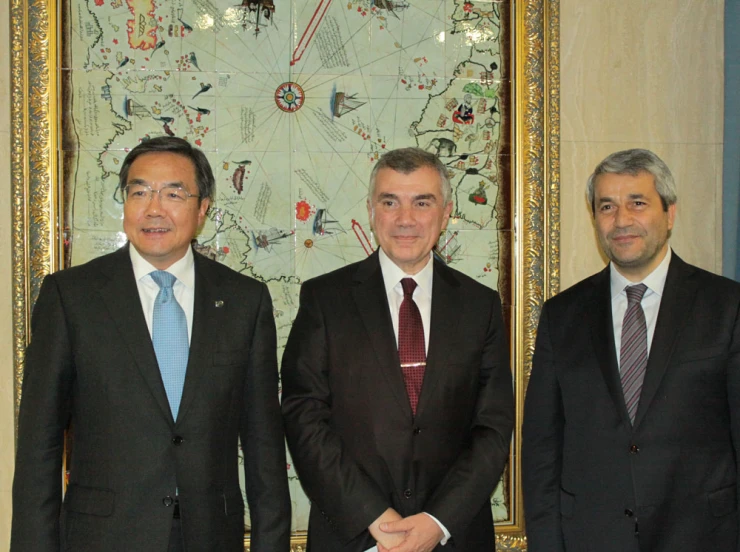 three men in business suits standing together