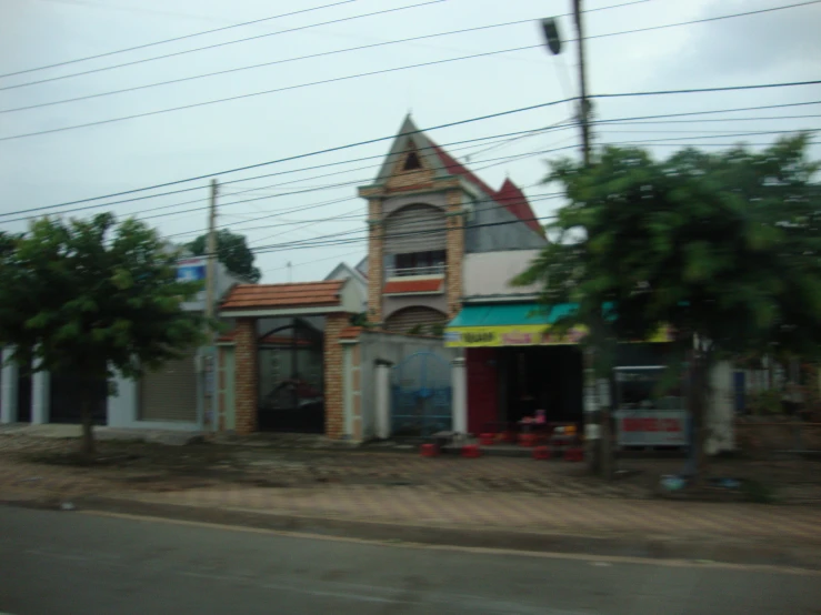 an old building with a tower stands beside an empty street