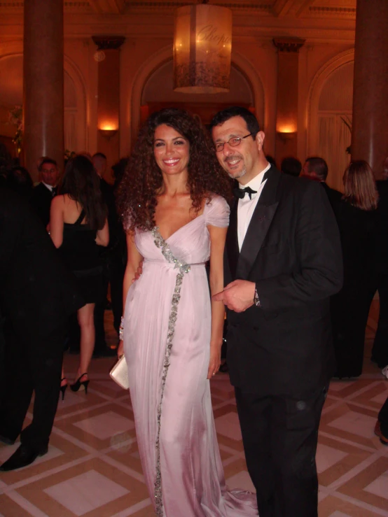 the young man and woman are smiling as they pose for a picture