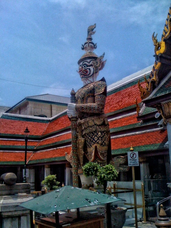 an ornate chinese sculpture sitting on the side of a road