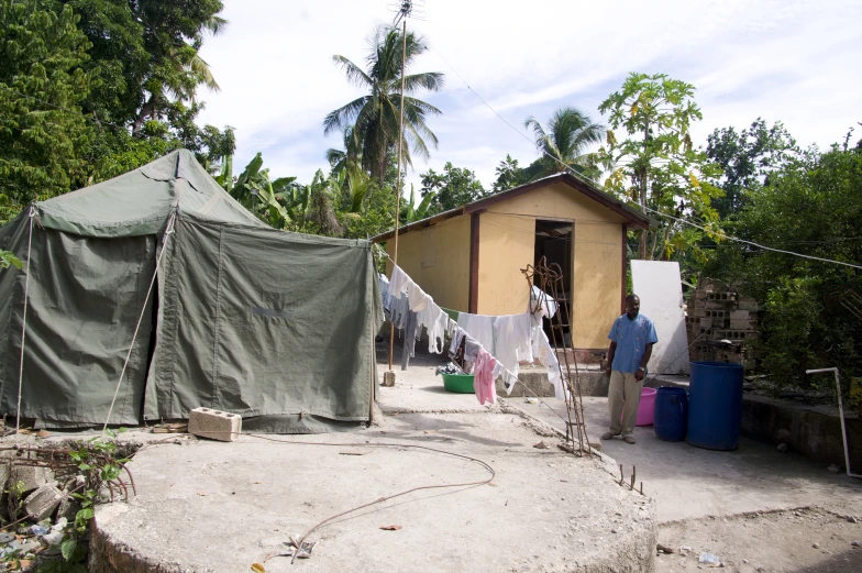 a couple of tents in the sand near houses