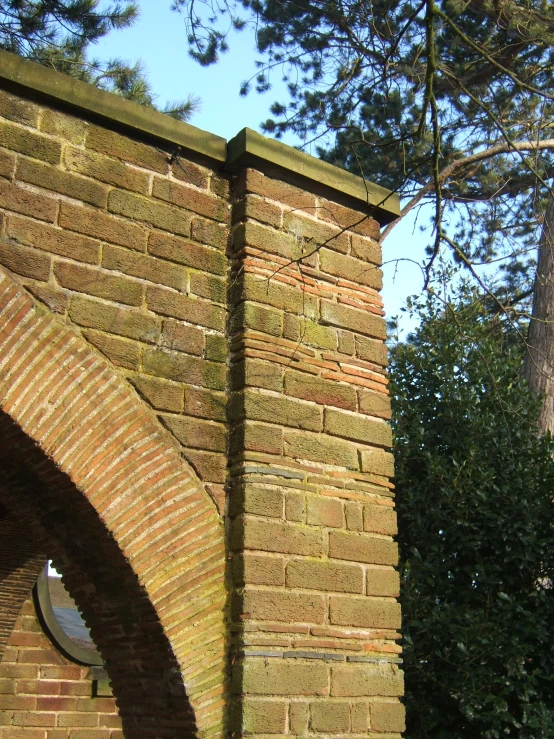 an arch is located behind a large brick building
