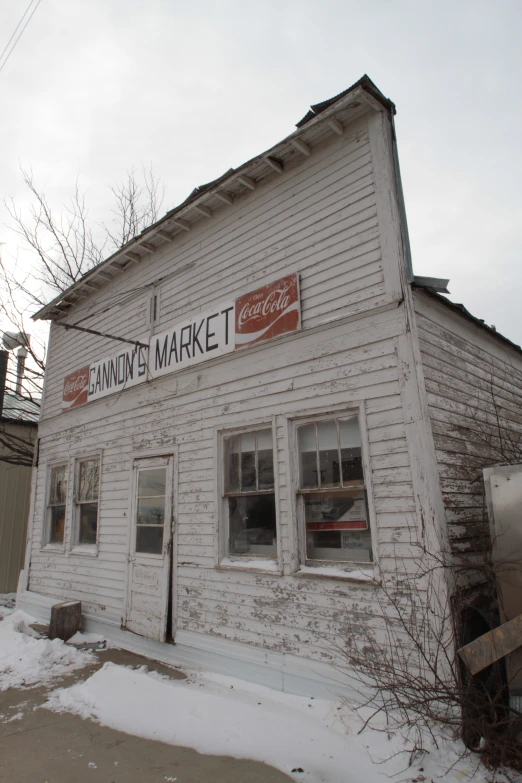 a store front with a sign and windows