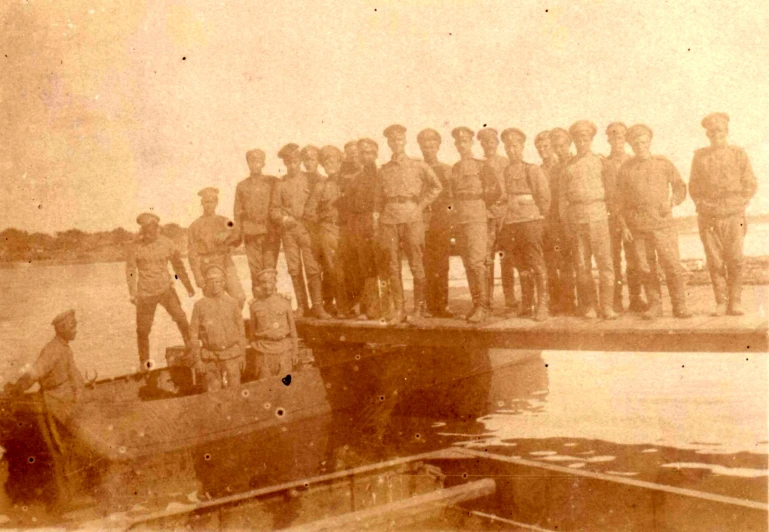 an old black and white po of a boat and a group of men