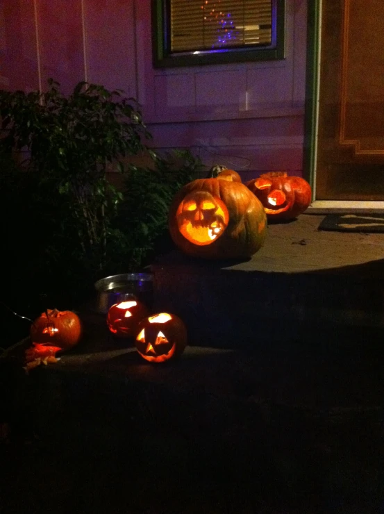 the front door has many jack - o'lanterns lit up