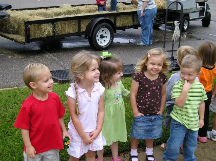 s standing in front of a truck near a field