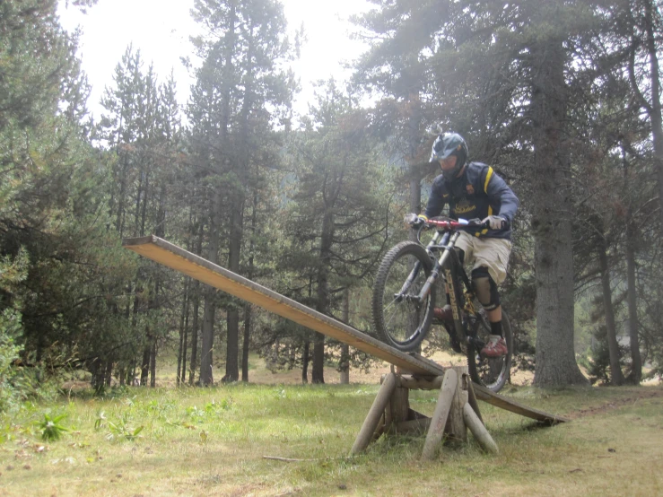 the man is riding his bike down the hill