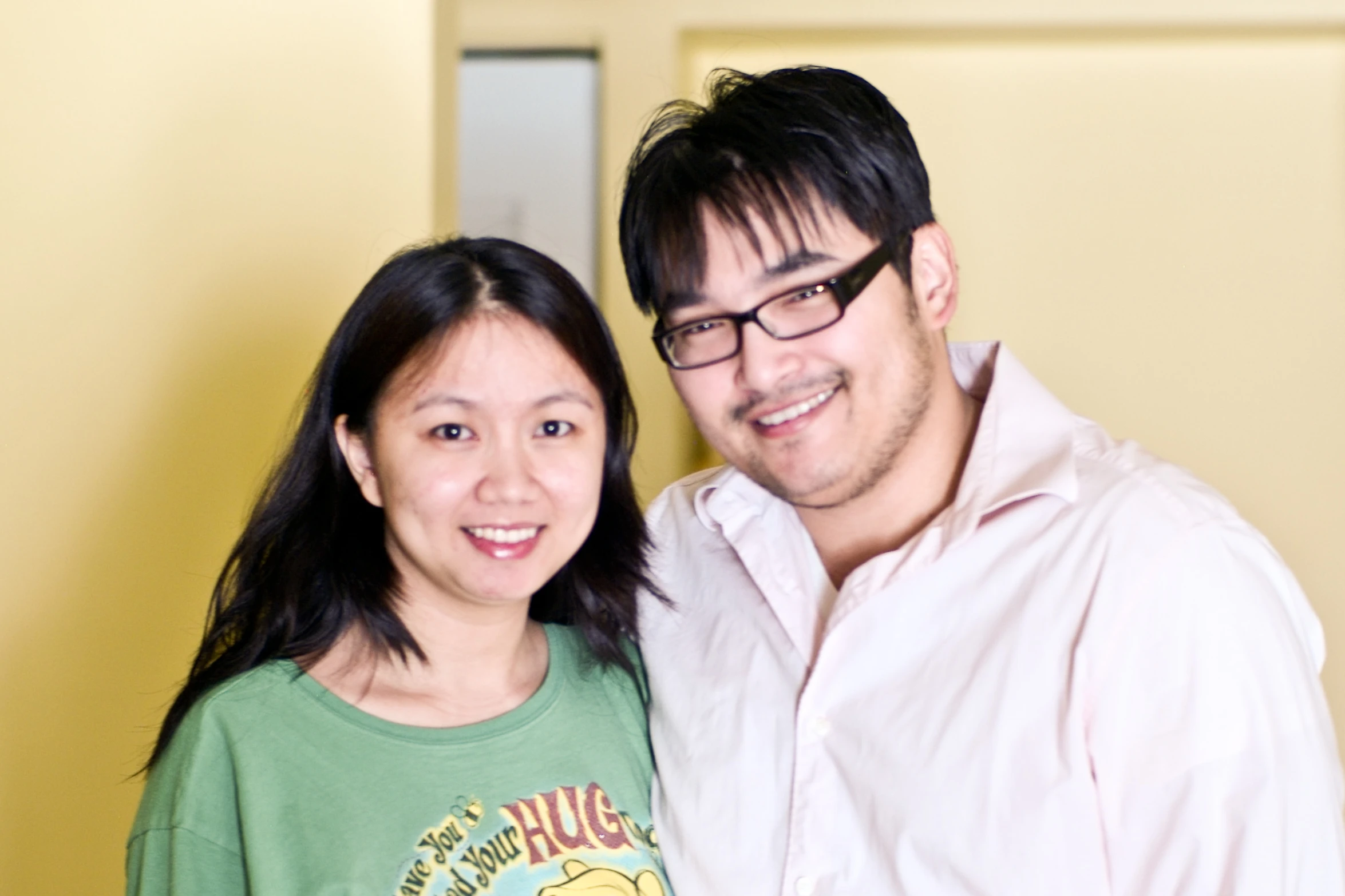 the man and woman are posing together in the hallway