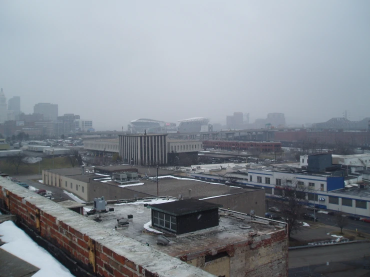 a building on the other side of the buildings on the opposite side of it is the skyline with a lot of high rise buildings and a big white cloud